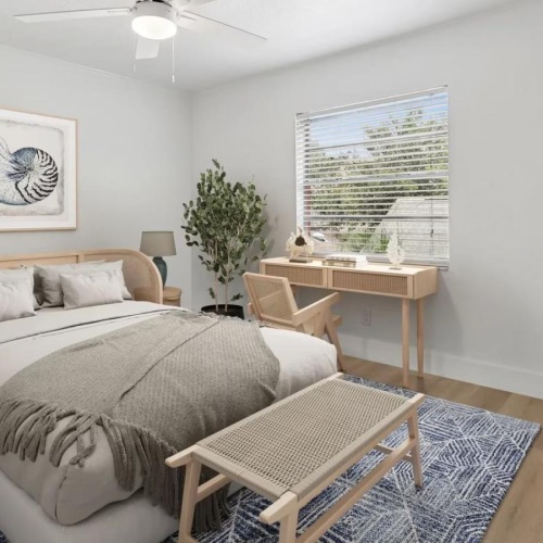 a bedroom with a bed and tables
