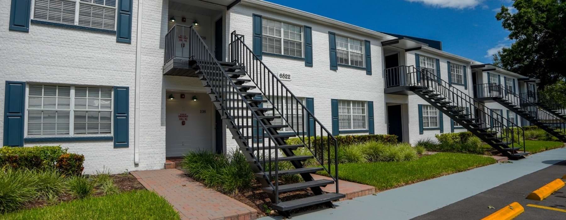 a building with stairs and grass