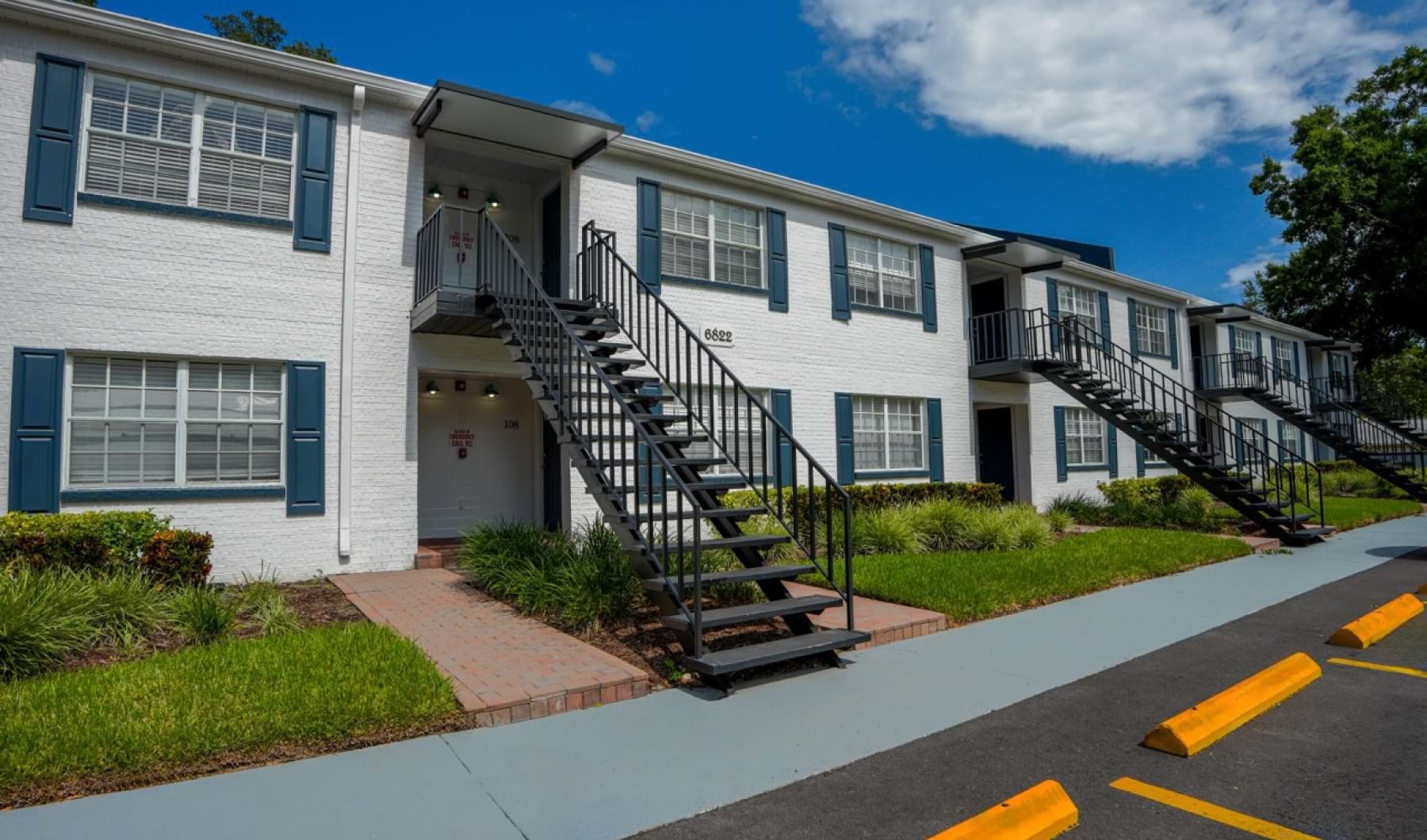 a building with stairs and grass